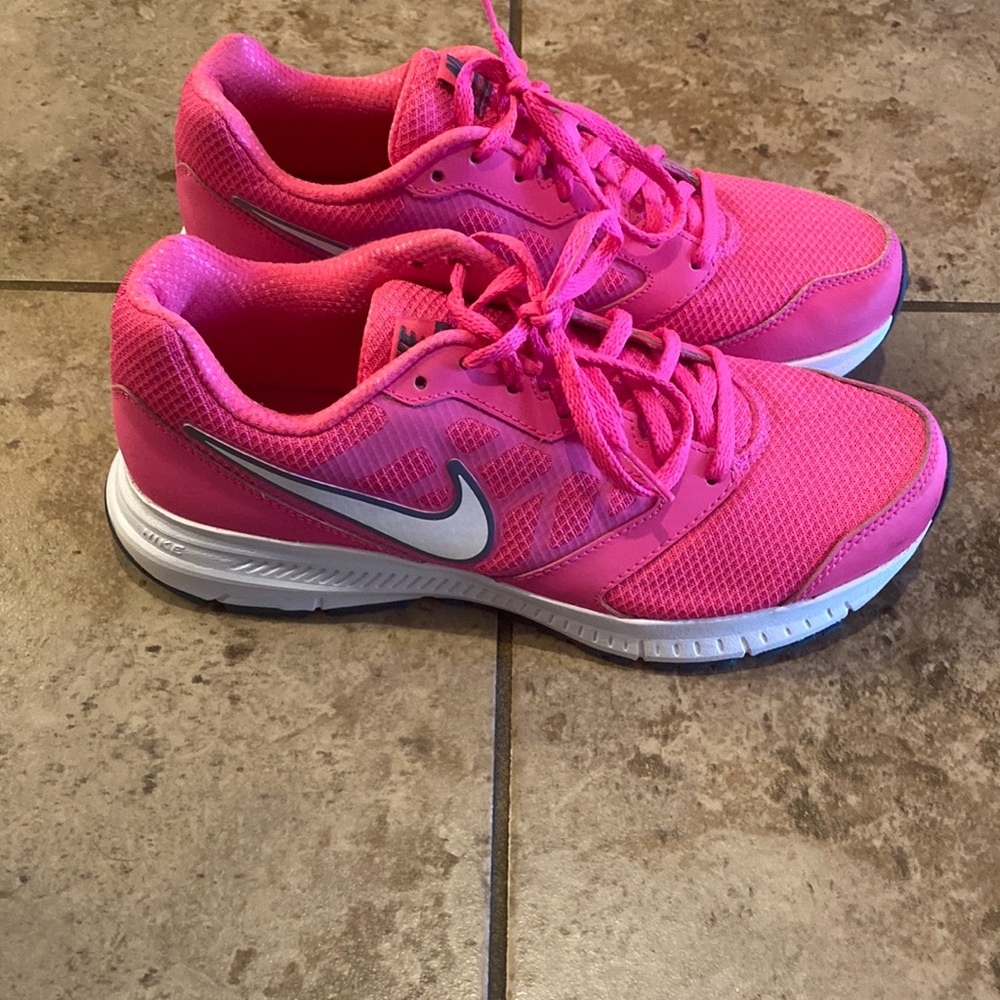 Hot pink Nike sneakers.